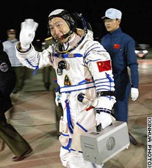 A relaxed Yang Liwei waves to well-wishers as he prepares to board the Shenzhou 5 capsule and take a ride into history